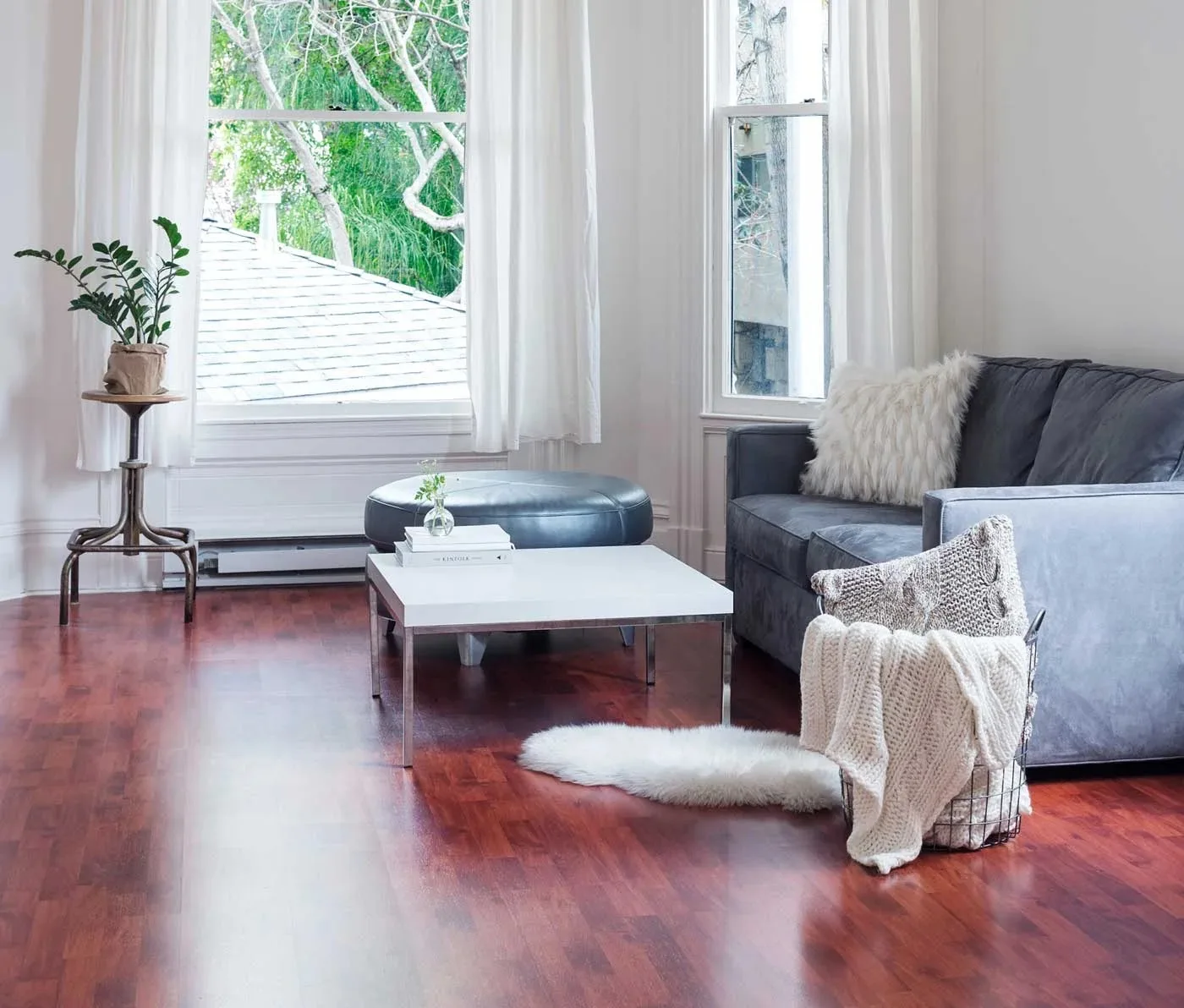 Bright living room with rich hardwood flooring installed by The Flooring House